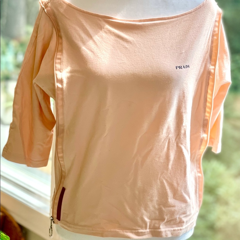 Prada’s wide neck, creamsicle shirt